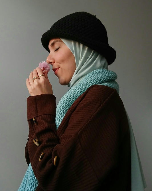 girl smelling piece of cloth